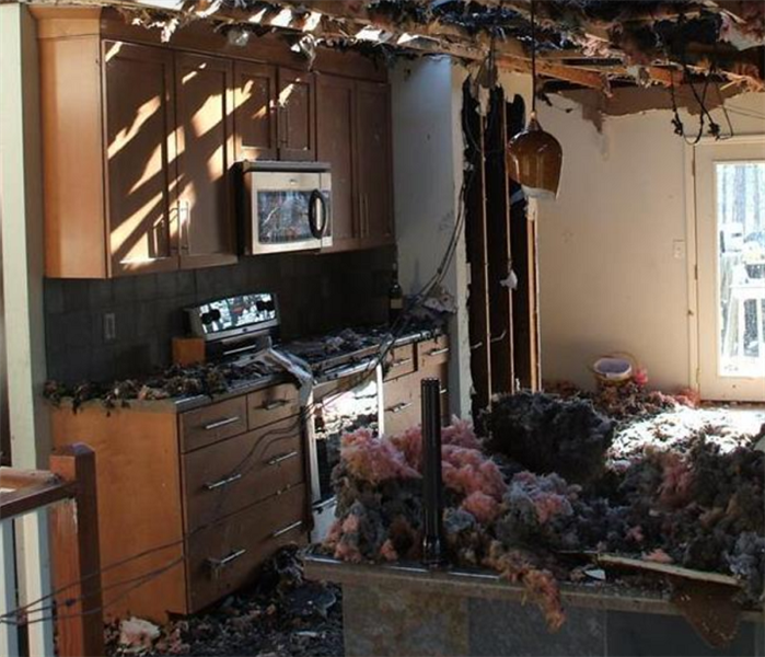Fire damaged kitchen; debris on floor