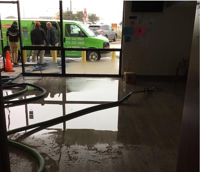 Office space with water damage and a SERVPRO van outside