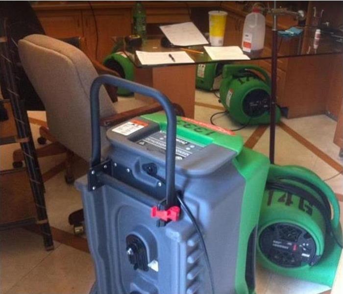 SERVPRO dehumidifier and air movers being used to dry water damaged room