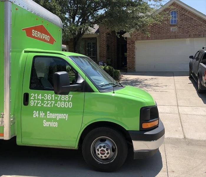 SERVPRO restoration vehicle in front of house