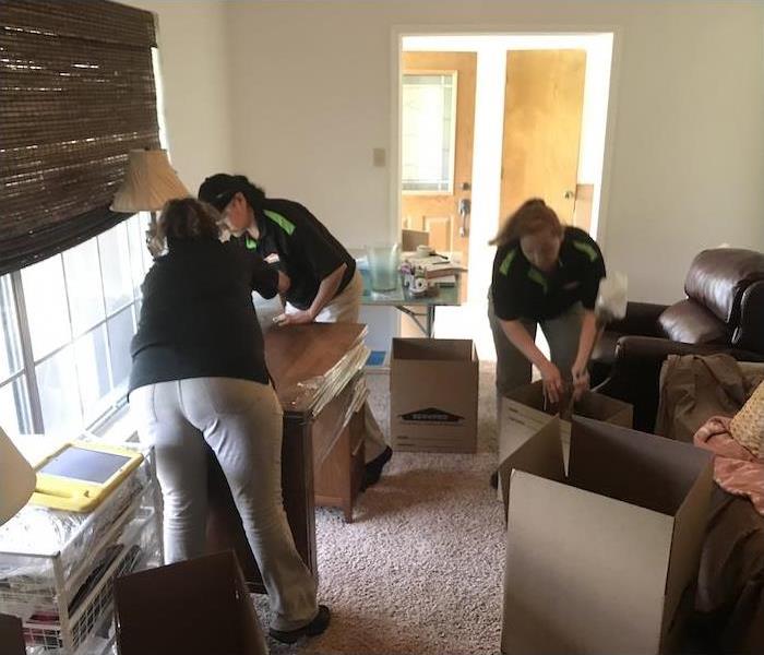 SERVPRO employees packing up fire damaged furniture