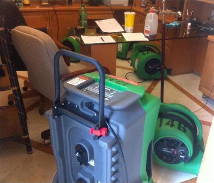 Our commercial air movers and dehumidifiers working to dry the materials in this property